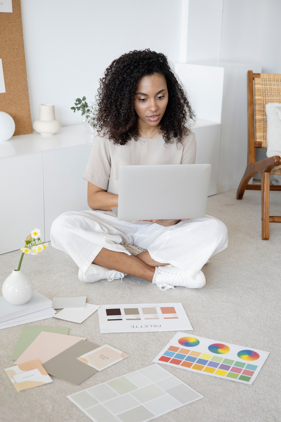 A Woman Using Her Laptop while Sitting on the Floor